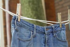 blue jeans hanging on a clothes line outside