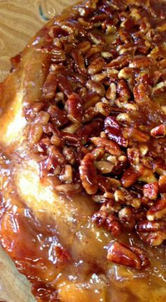 pecans and other nuts are on top of a pastry crusted in caramel