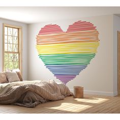 a bedroom with a large rainbow heart on the wall