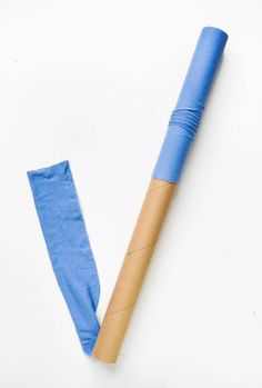 a rolled up piece of blue paper next to a wooden stick