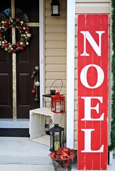 a red and white sign that says noel on it's front porch next to a door