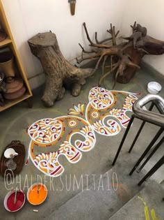 the floor is decorated with colorful designs and colors, while other items are scattered around