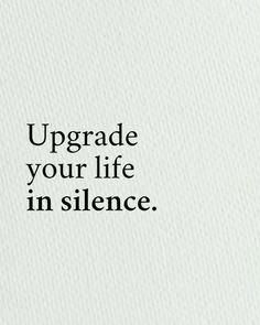 the words upgrade your life in silence are written on a white paper with black ink