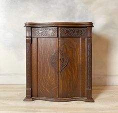 an old wooden cabinet with carvings on the doors