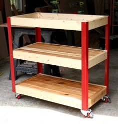 a three tiered wooden cart in a garage