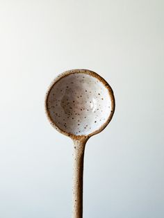 a white ceramic spoon sitting on top of a table