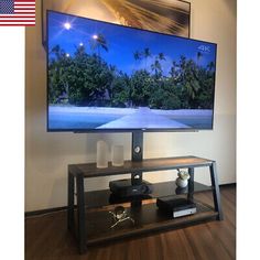 a flat screen tv sitting on top of a wooden stand