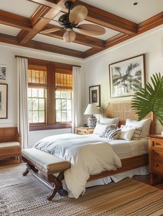 a bedroom with a bed, dresser and ceiling fan