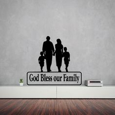 a family sign with the words god bless our family on it in front of a gray wall