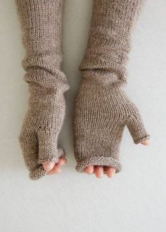 someone is holding their hands up to show the mittens on top of them