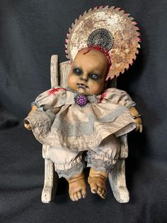 a creepy doll is sitting on a chair