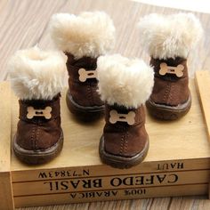 four pairs of brown boots with white fur lined up on top of eachother