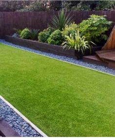 a small backyard with grass and wooden steps