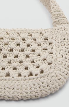 a white crocheted purse on a white surface