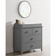 a gray dresser with two drawers and a mirror above it