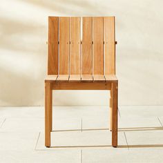 a wooden chair sitting on top of a tile floor