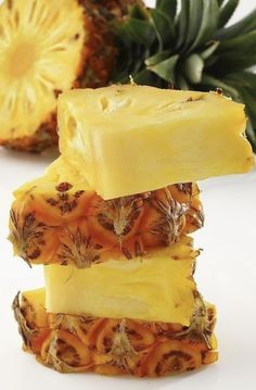 pineapple slices stacked on top of each other next to a pineapple slice with leaves