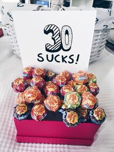 there is a sign that says 30 sucks in front of some candies on the table