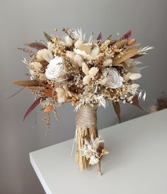 a bouquet of dried flowers is sitting on a table