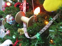 a christmas tree decorated with ornaments and measuring tape