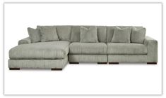 a sectional couch with pillows on it and the bottom half facing off to the side