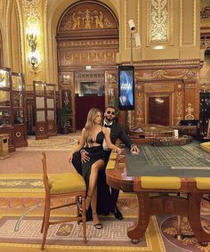 a man and woman sitting at a casino table