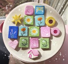 a white plate topped with lots of different colored cookies and decorations on top of it