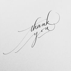 the word thank you written in cursive ink