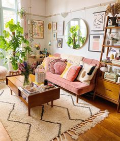 a living room filled with furniture and plants