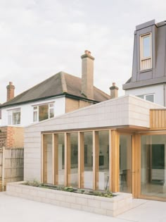 a house that is made out of wood and brick with an extension to the roof