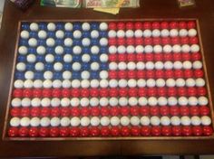 an american flag made out of red, white and blue balls sitting on top of a table