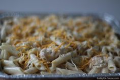 a casserole dish with chicken, cheese and noodles