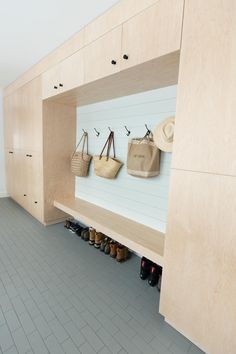 there are many shoes and bags on the wall