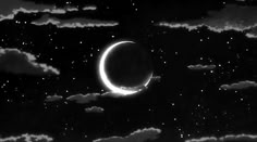 a crescent in the night sky with clouds