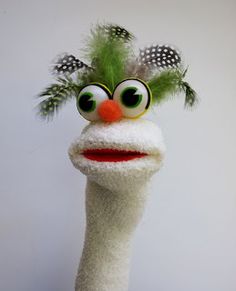 an ostrich's head with green hair and big eyes is shown in front of a white wall