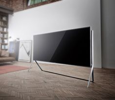 a flat screen tv sitting on top of a wooden floor