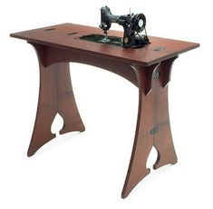 an old sewing machine sitting on top of a wooden table