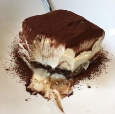 a piece of chocolate dessert with ice cream and oreo crust on a white plate