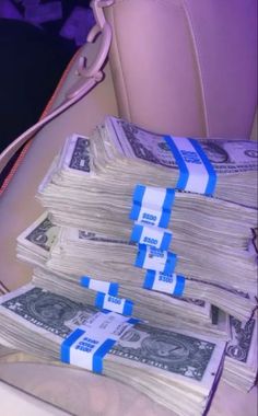 stacks of money sitting on top of a car seat