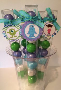 a clear vase filled with candy covered in blue and green candies on top of a table