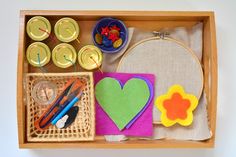 a wooden box filled with crafting supplies