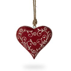 a red heart shaped ornament hanging from a rope