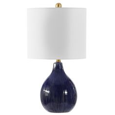 The artisanal styling and vivid hues of this Calrus Table Lamp transform any room into a sensationally palatial retreat. Calrus flaunts organic striations in blue crackle ceramic that beautifully offset its flowing gourd silhouette, while shining gold hardware makes it radiantly regal. Care Instructions: Before cleaning any lamp shade or fixture, disconnect the power source. Wipe with a soft, dry cloth. Avoid the use of chemicals and household cleaners as they may damage the finish. Navy Table, Blue Shades Colors, Brass Light Fixture, Blue Table Lamp, Car Wax, Blue Table, Outdoor Light Fixtures, Brass Lighting, Led Table Lamp