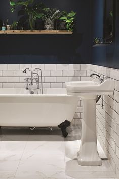 a white bath tub sitting next to a sink in a bathroom