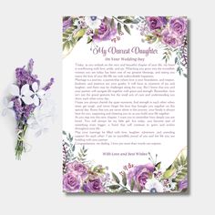 a purple and white floral wedding program with flowers on the front, and an envelope in the back