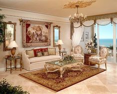 a living room filled with furniture next to a window covered in curtains and drapes