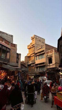 an outdoor market with people walking around it