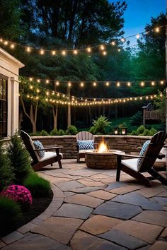 an outdoor fire pit surrounded by chairs and lights