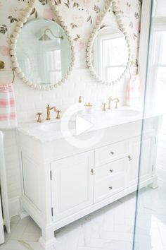 a bathroom with two sinks and mirrors on the wall