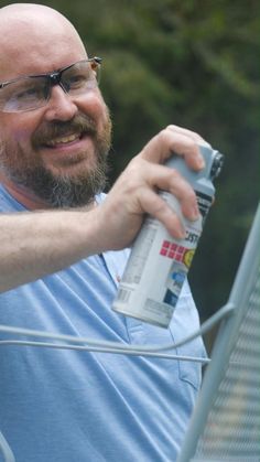 a man holding a spray paint can in his right hand